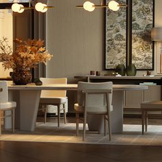 a dining room table with four chairs and a vase filled with flowers on top of it