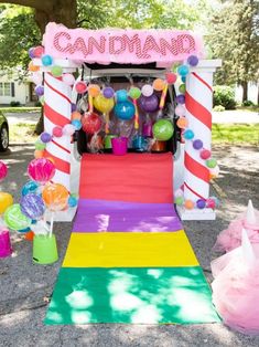 an ice cream cart decorated with candy and balloons for a candy land birthday party or baby shower