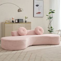 a pink couch sitting on top of a white rug