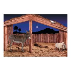 two donkeys and a sheep in a barn at night with a star above them