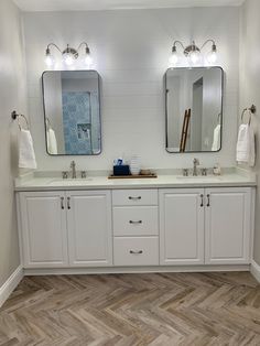 a bathroom with two sinks and mirrors in it