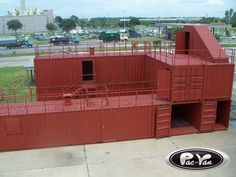 a large red building sitting on top of a parking lot