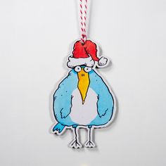 an ornament with a bird wearing a santa hat