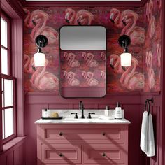 a bathroom with pink walls and two sinks