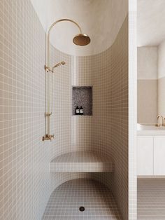 a bathroom with tiled walls and flooring next to a walk in shower