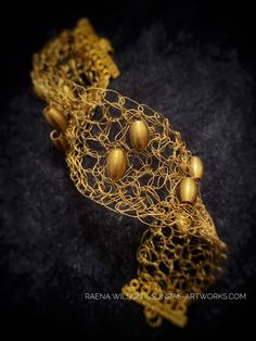 "In my wire art pieces, I am inspired by simplicity, texture, color, movement... the form flows in the moment as I \"draw\" in space, as if the wire were ribbons of ink.  \"Elegantly Bold\" -- Brass Wire Crochet Beaded Bracelet Wire Art Jewelry I love the way metal can flow--which seems counterintuitive, because metal is hard and rigid! It excites my senses to work with creating ribbons of \"fabric\" metal, that is also comfortable and has a beautiful drape. Brass wire crocheted with brass beads Wire Art Jewelry, Crochet Beaded Bracelet, My Senses, Crochet Beaded Bracelets, Star Tree Topper, Wire Crochet, Wire Sculpture, Beautiful Drapes, Red Accents