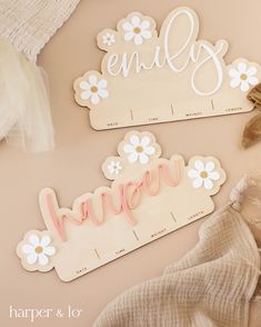 two wooden name plaques sitting on top of a table