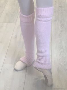 the legs of a doll wearing pink socks