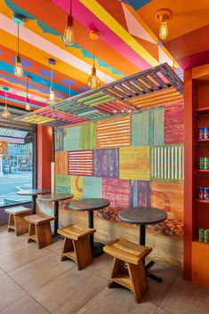 a brightly colored restaurant with wooden tables and benches