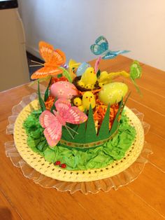 a cake decorated with flowers and butterflies on a table