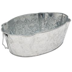 a large metal bowl with flowers and leaves on the rim, sitting in front of a white background