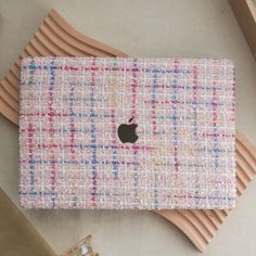 an apple computer sitting on top of a wooden table