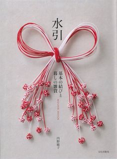 a red and white ribbon tied to a piece of paper with chinese characters on it