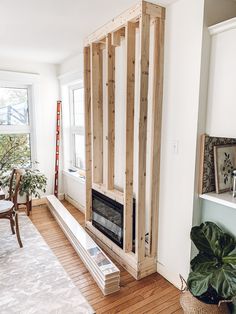 a living room filled with furniture next to a fire place in a home under construction