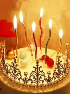 a birthday cake with candles and decorations on it