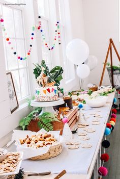 a long table filled with lots of food and desserts on it's sides