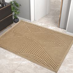 a beige door mat sitting on top of a floor next to a dresser and cabinet