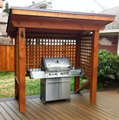 an outdoor grill area with a wooden pergolan on the side and a grill in the middle