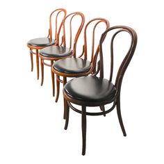 four chairs with curved backrests and black leather seat pads on each one side