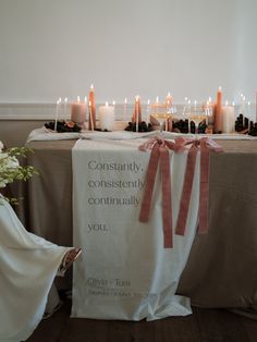 a table with candles and a sign on it that says constantly contemplately you