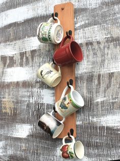 coffee cups are lined up on a wooden board