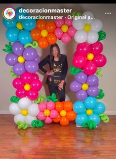 a woman standing in front of a balloon arch