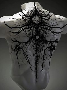 the back of a mannequin's torso with tree roots on its chest