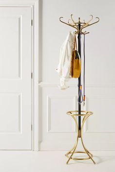 a coat rack with clothes hanging on it