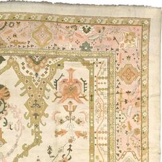 an antique rug with various colors and designs