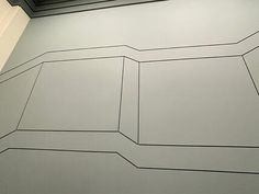 a white wall with black lines on it