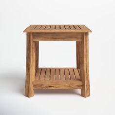 a small wooden side table on a white background