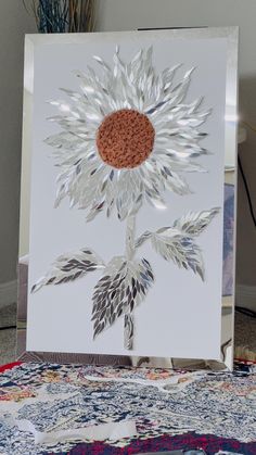 a white card with a sunflower cut out of it