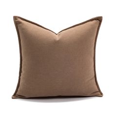 a brown pillow on a white background