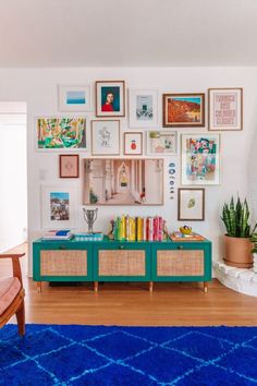 a living room filled with furniture and pictures on the wall