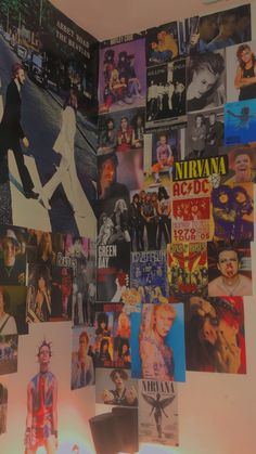 a wall covered with posters and pictures of people in different colors, sizes and styles