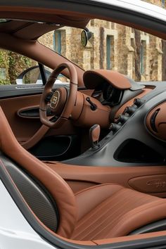 the interior of a sports car with brown leather