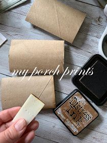 a person is holding a piece of wax paper next to some other items on a table