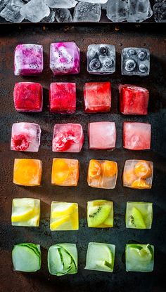 many different colored ice cubes on a table