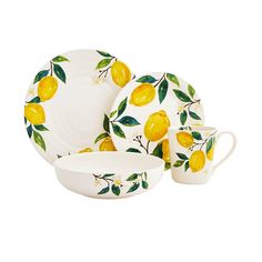 a yellow and white dinner set with lemons on it