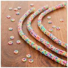 colorful sprinkles are scattered on a wooden surface