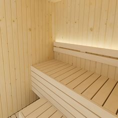 the inside of a wooden sauna with two benches and one bench on each side