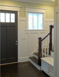 an empty entryway with stairs leading up to the door