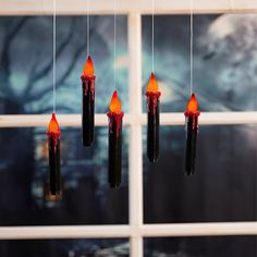 a group of red lights hanging from the side of a window