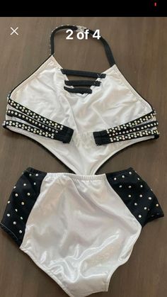 two pieces of white and black swimsuit with gold studdings on the sides