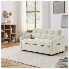 a white couch sitting on top of a rug in a living room next to a window