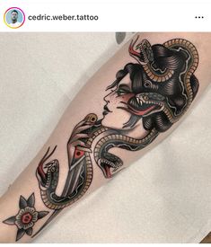 a woman with a snake tattoo on her leg