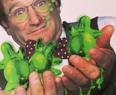 a man is holding up some green candies