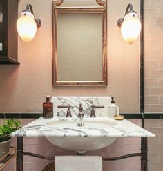 a white sink sitting under a mirror in a bathroom