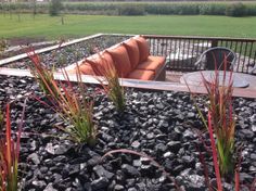 a couch sitting on top of a pile of rocks