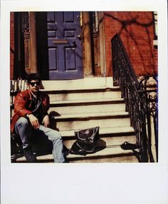 a man sitting on the steps of a building